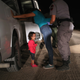 A 2-year-old Honduran asylum seeker cries as her mother is searched and detained near the U.S.-Mexico border on June 12, 2018, in McAllen, Texas.
